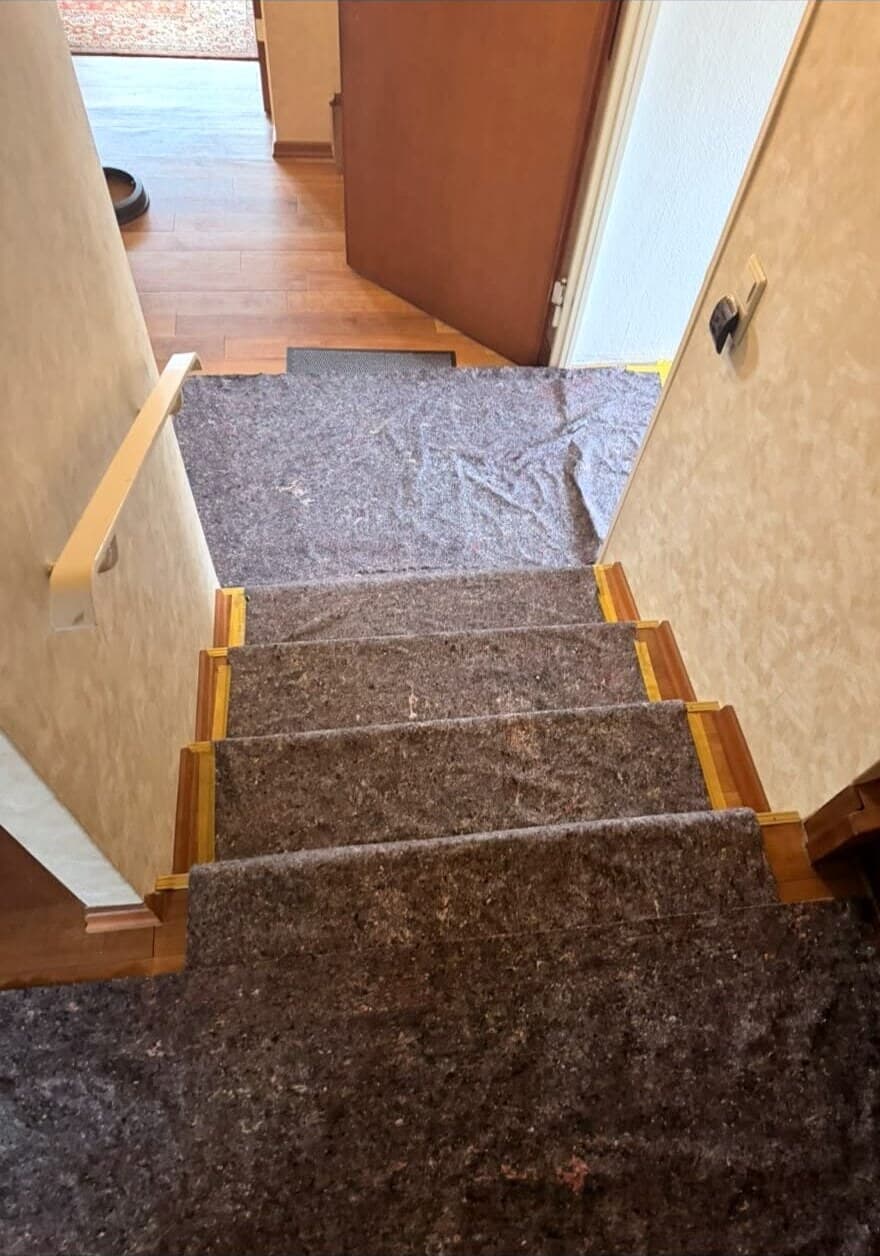 Treppe während der Arbeiten, Stufen mit Malervlies abgedeckt