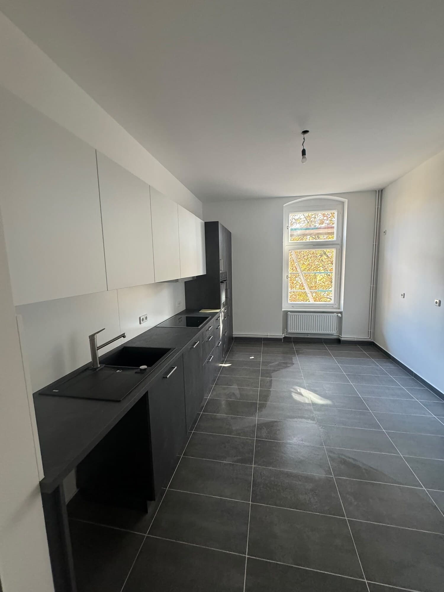 Neue Einbauküche mit Fliesenboden im Altbau